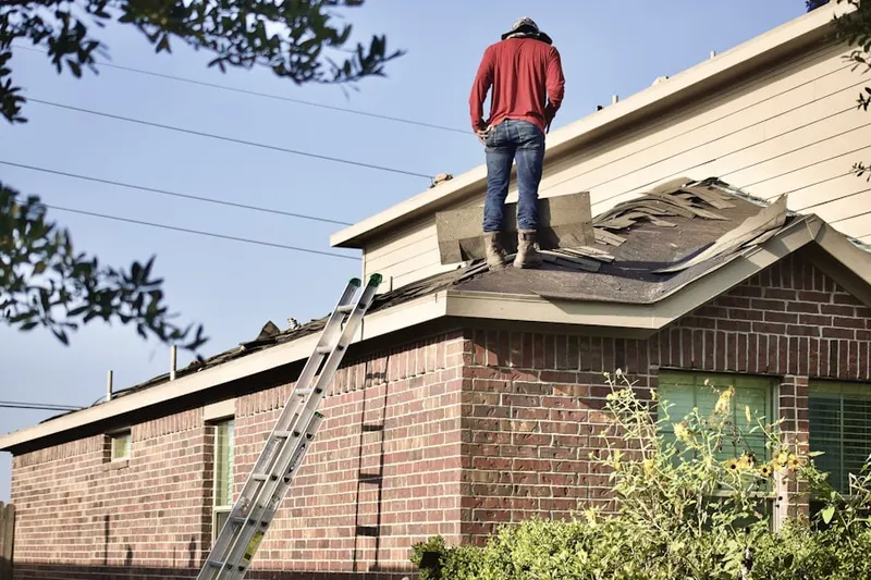 Professional roofer working on a residential roof in Elmcrest